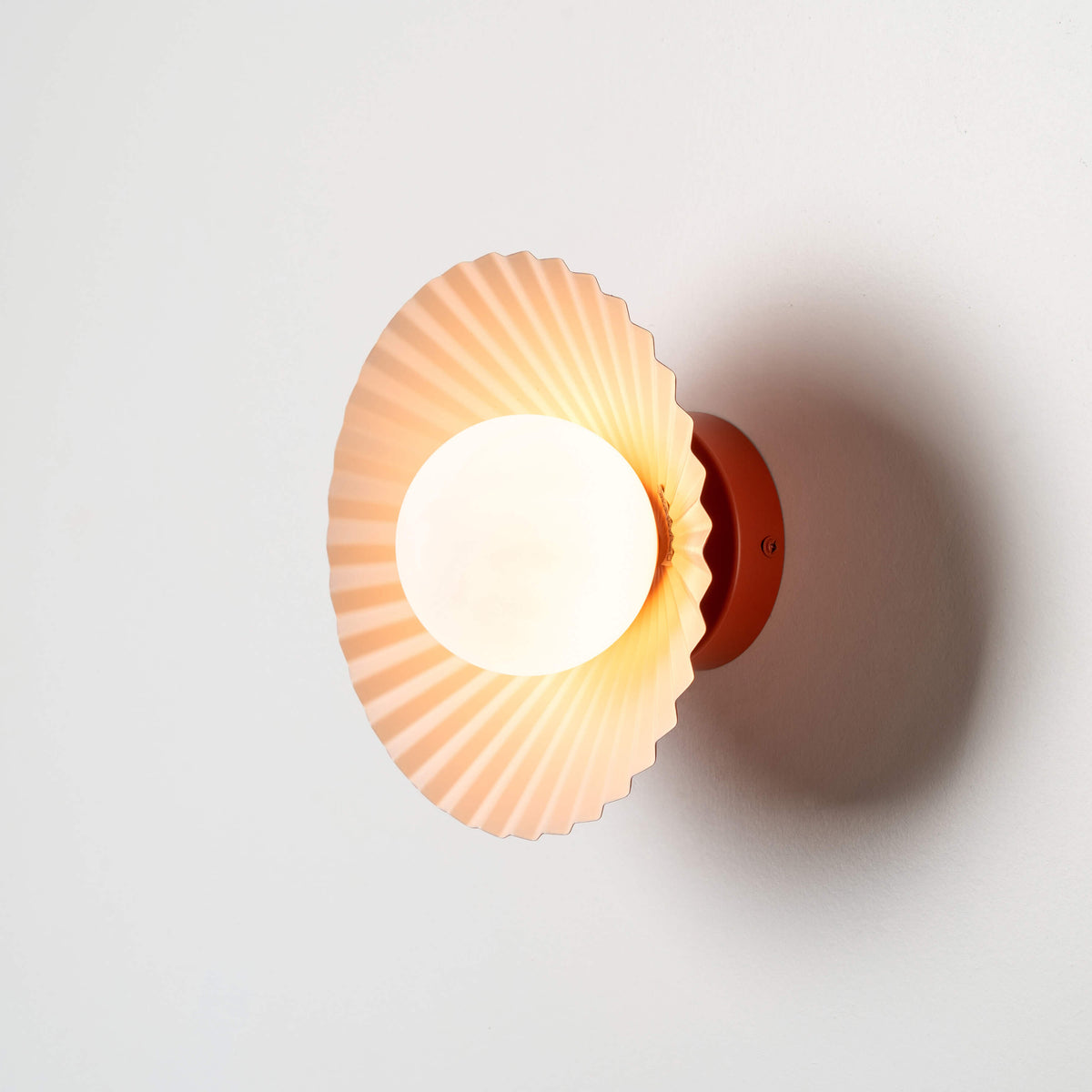 Burnt orange flush pleat wall light